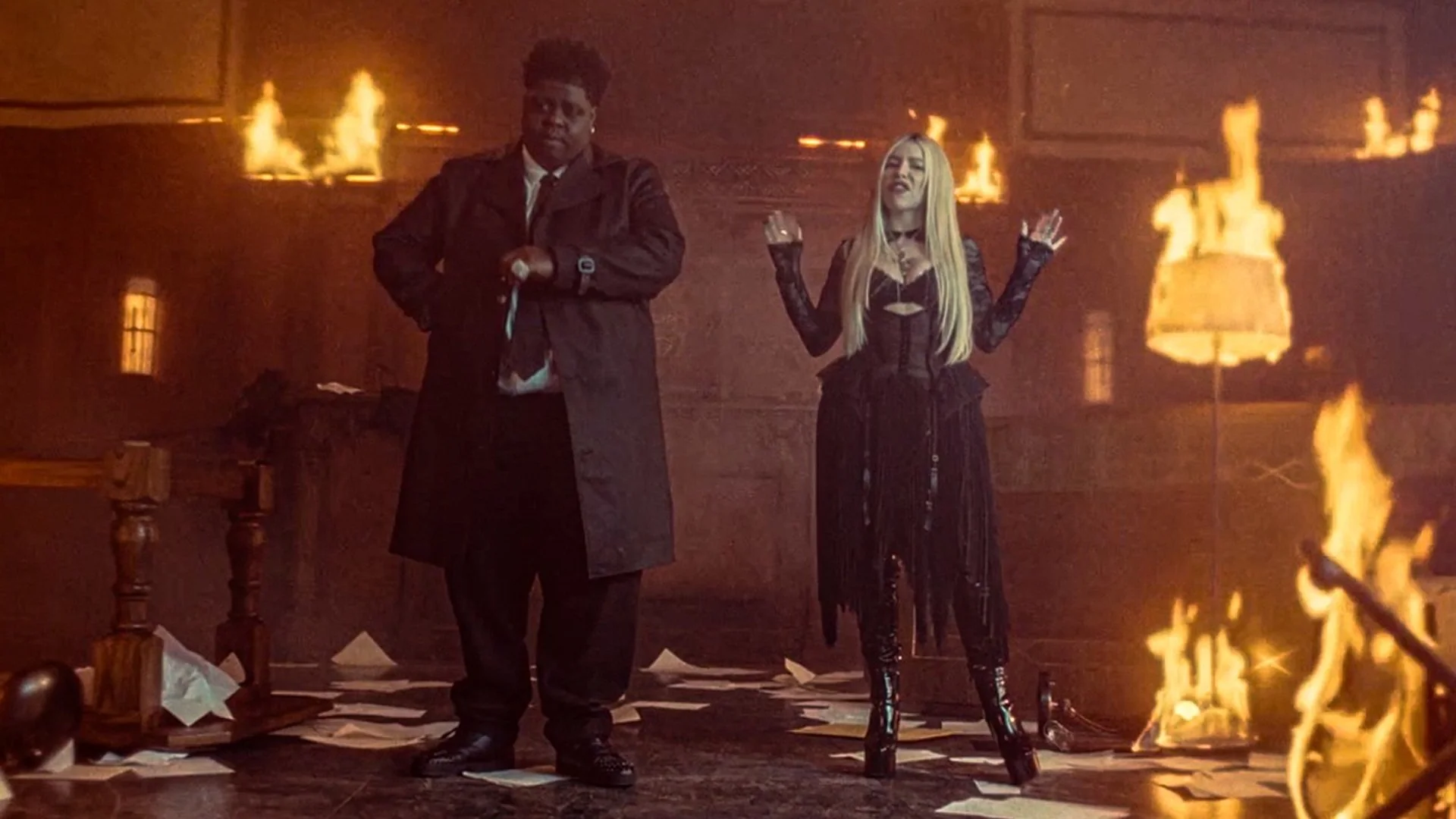 BigXthaPlug and Ava Max standing in a burning room in the BURN music video