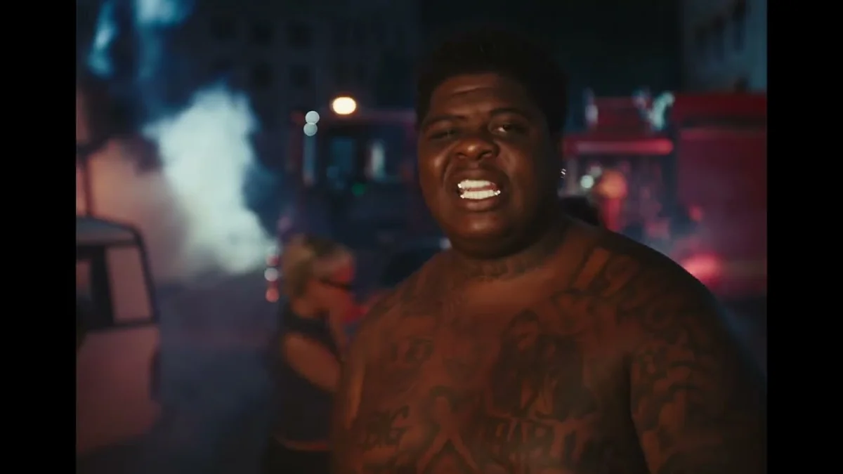 BigXthaPlug shirtless under red and blue lights in the BURN music video